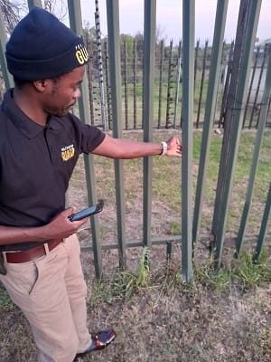 Guard inspecting a perimeter fence