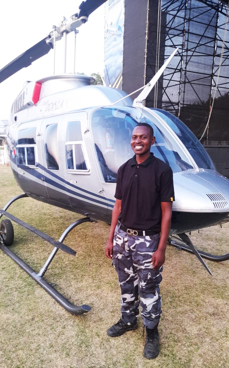 Guard beside a helicopter on display