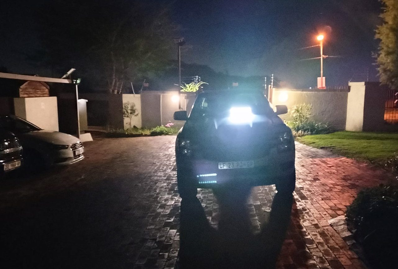 Patrol vehicle at a gate at night